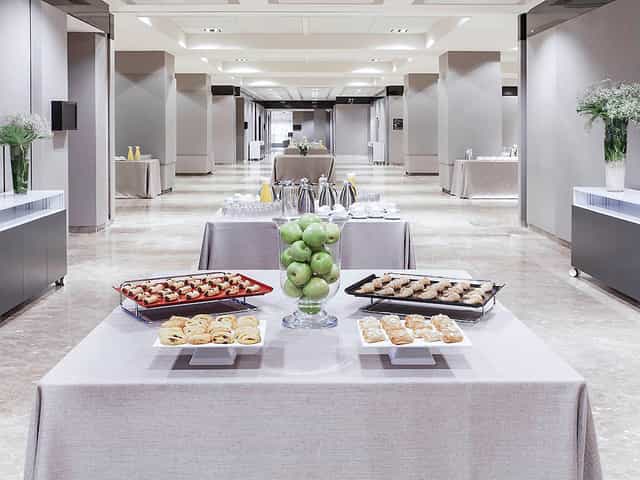 Elegant meeting space at Novotel Center with arranged tables for corporate events.