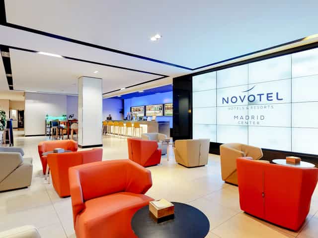 Modern hotel lobby with sleek design, ideal for meetings and networking events.