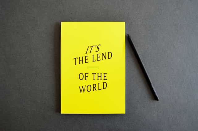 Vibrant yellow notebook and black pen for creative event planning at Lendhotel.