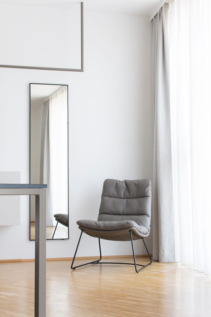 Minimalist meeting space at Lendhotel with modern chair and natural light for events.