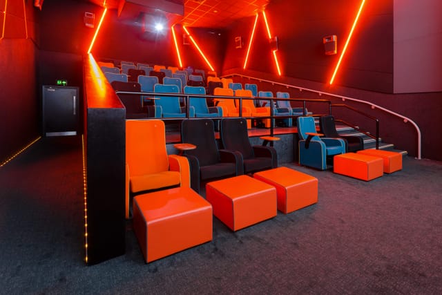 Modern auditorium with colorful seating at The Light Cinema Stockport for events and meetings.