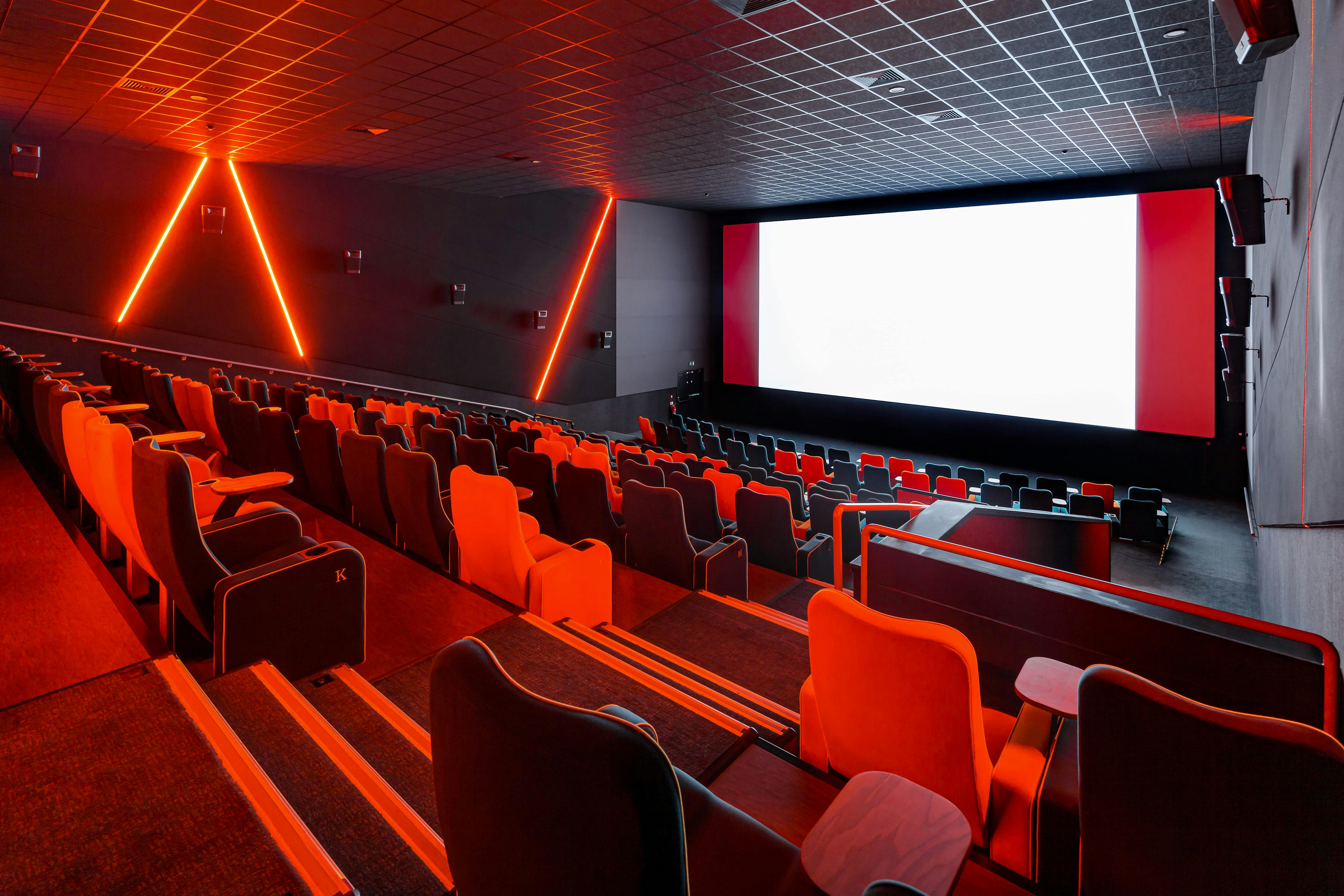 Modern cinema auditorium with tiered seating for film screenings and corporate events.