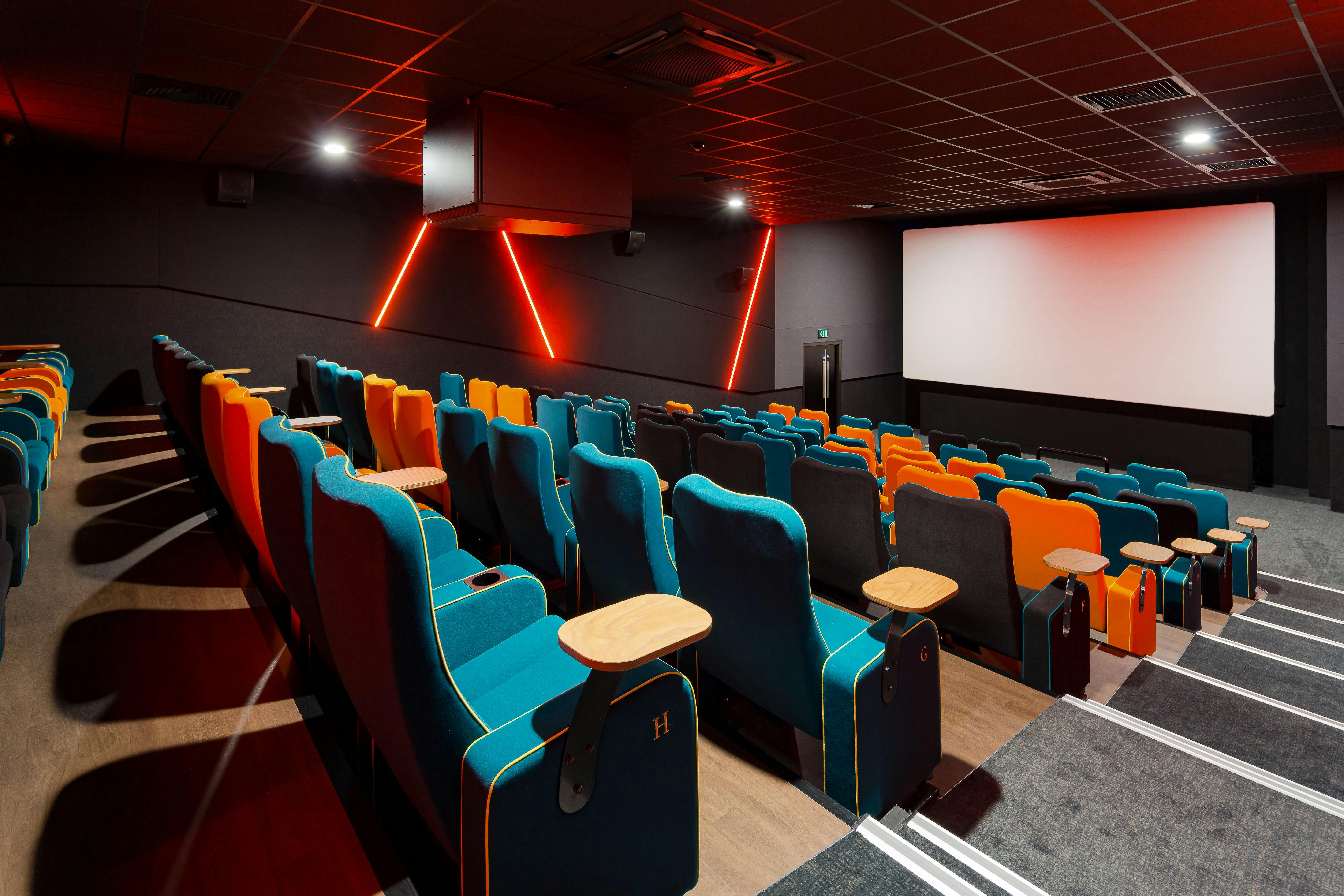 Modern cinema venue with vibrant seating for film screenings and corporate events.