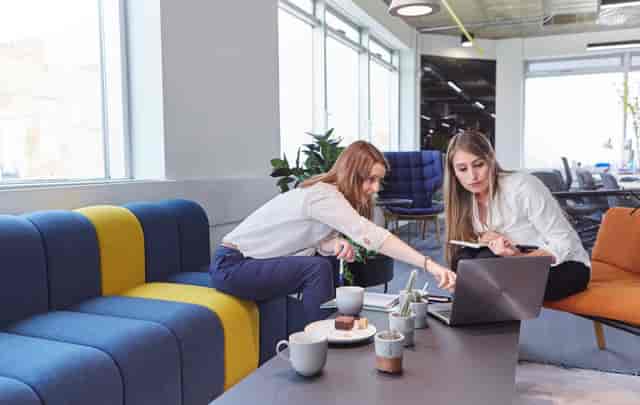 Collaborative workspace with colorful furniture for team-building events and workshops.