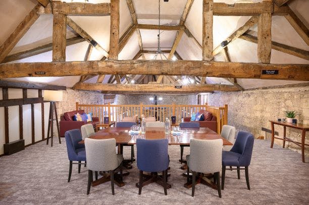 Stylish meeting space with wooden beams at voco™ Oxford Thames Hotel for events and brainstorming.