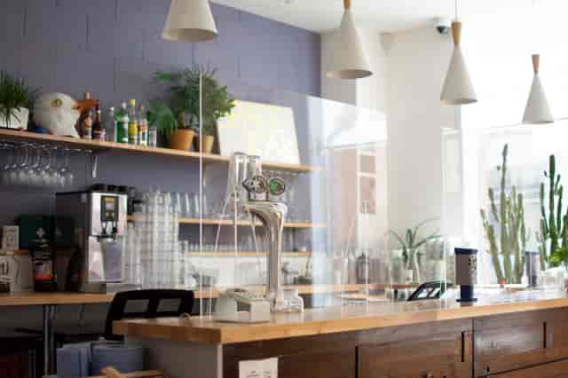 Modern bar with acrylic barrier at Streatham Space Project for safe networking events.