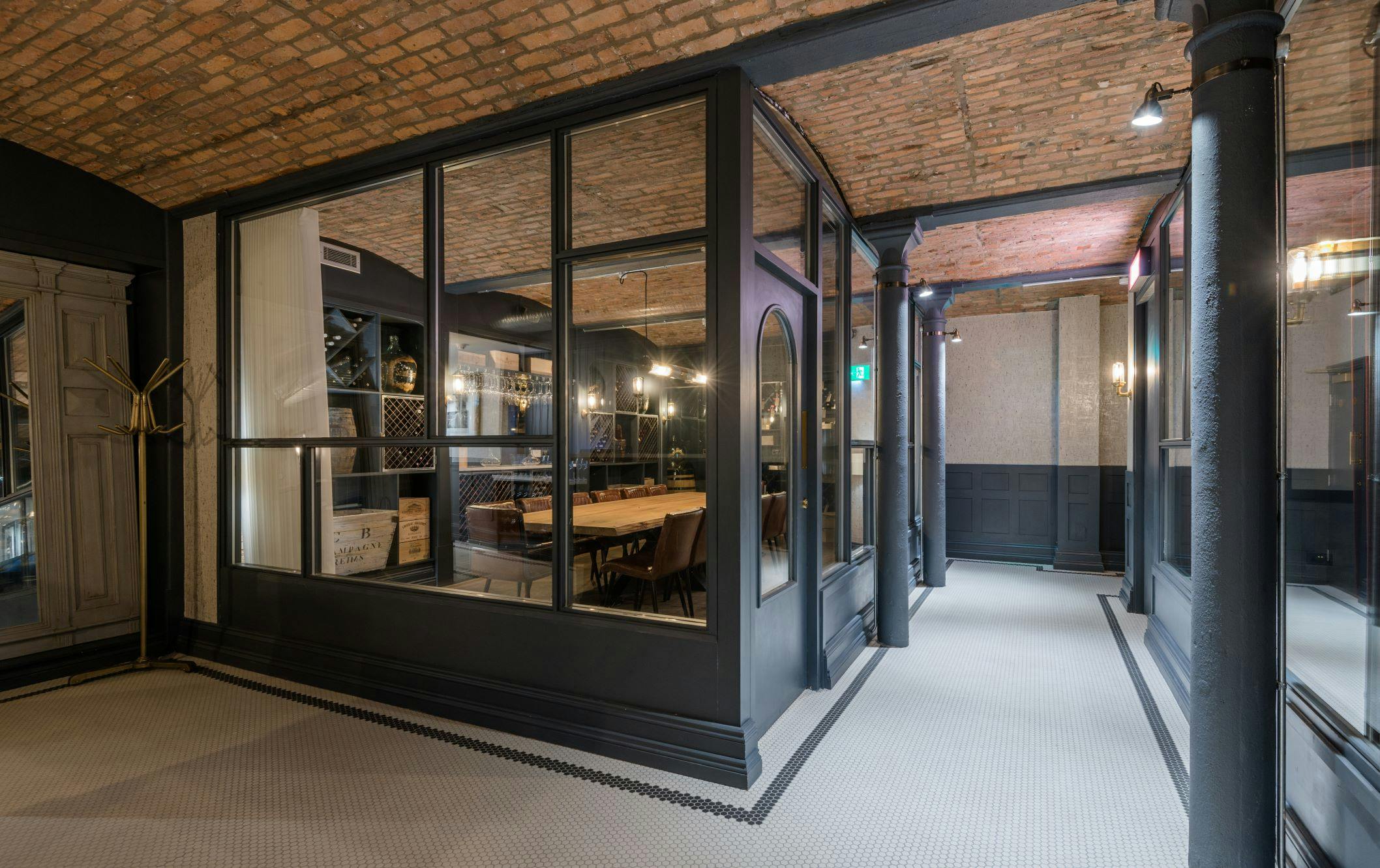 Stylish meeting space with exposed brick ceiling at King Street Townhouse Wine Cellar.