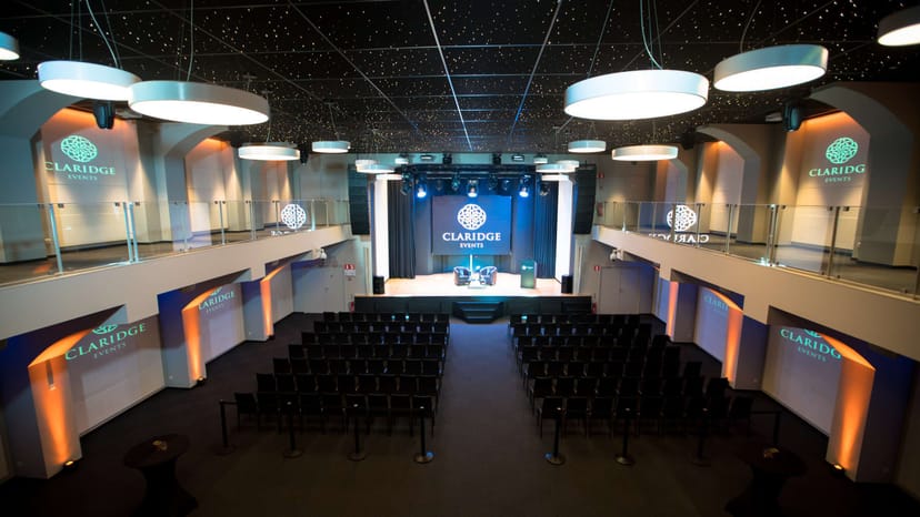 Claridge Events stage with professional lighting, ideal for conferences and presentations.