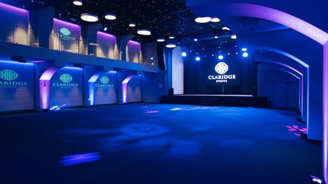 Versatile event space at Claridge with modern decor for corporate and social gatherings.
