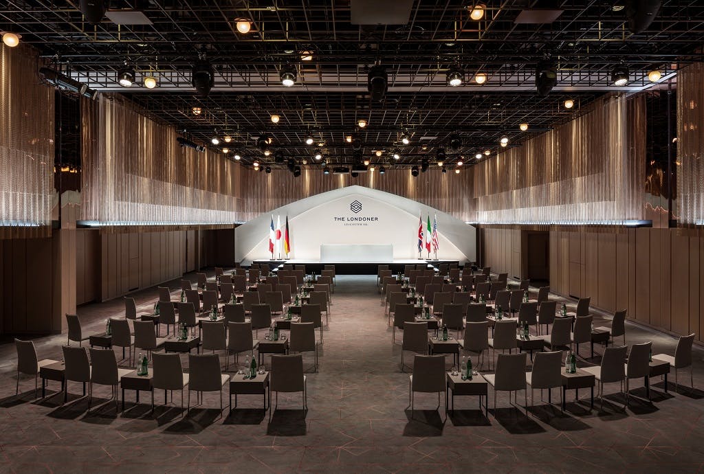 Ballroom B at The Londoner, formal event setup with stage and arranged seating.