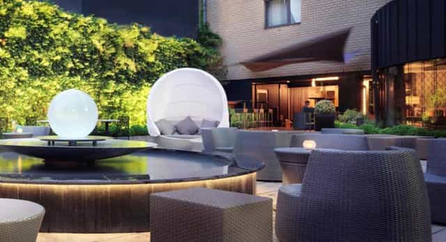 Stylish outdoor event space at Sofitel Brussels with modern seating and water feature.