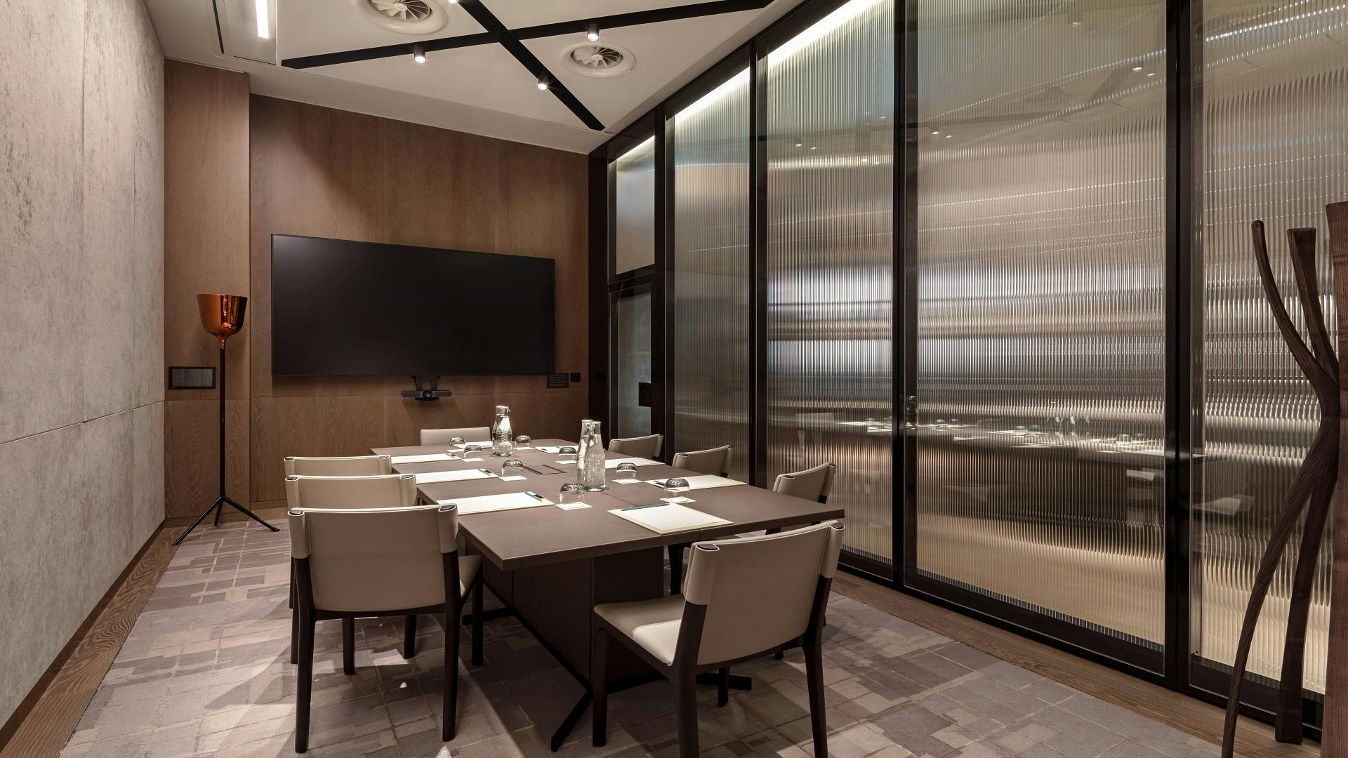 Modern meeting room at Somerset House, featuring glass walls and sleek decor for conferences.