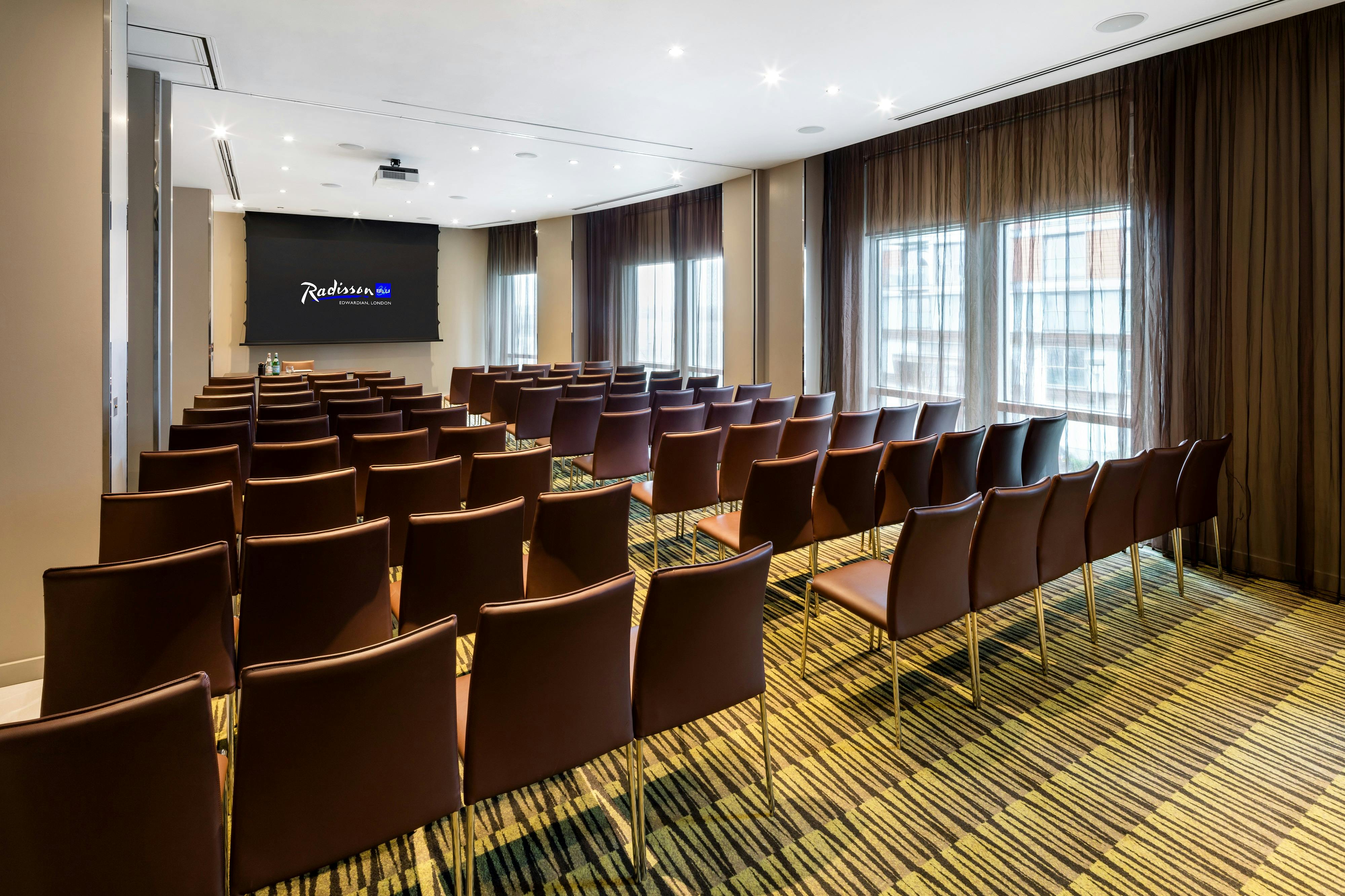 Private meeting room with modern chairs and natural light at Radisson Blu Edwardian.