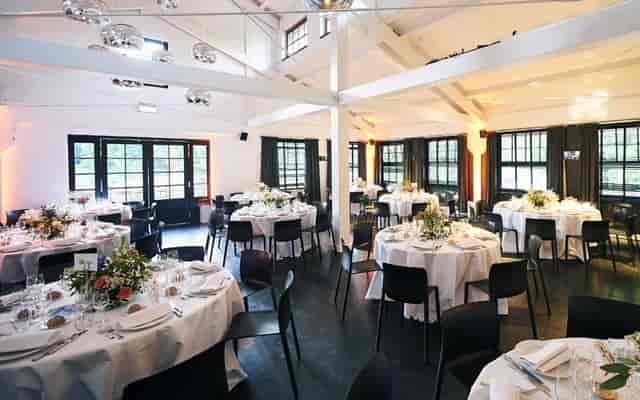 Elegant event space at Chalet Robinson with round tables and floral centerpieces.
