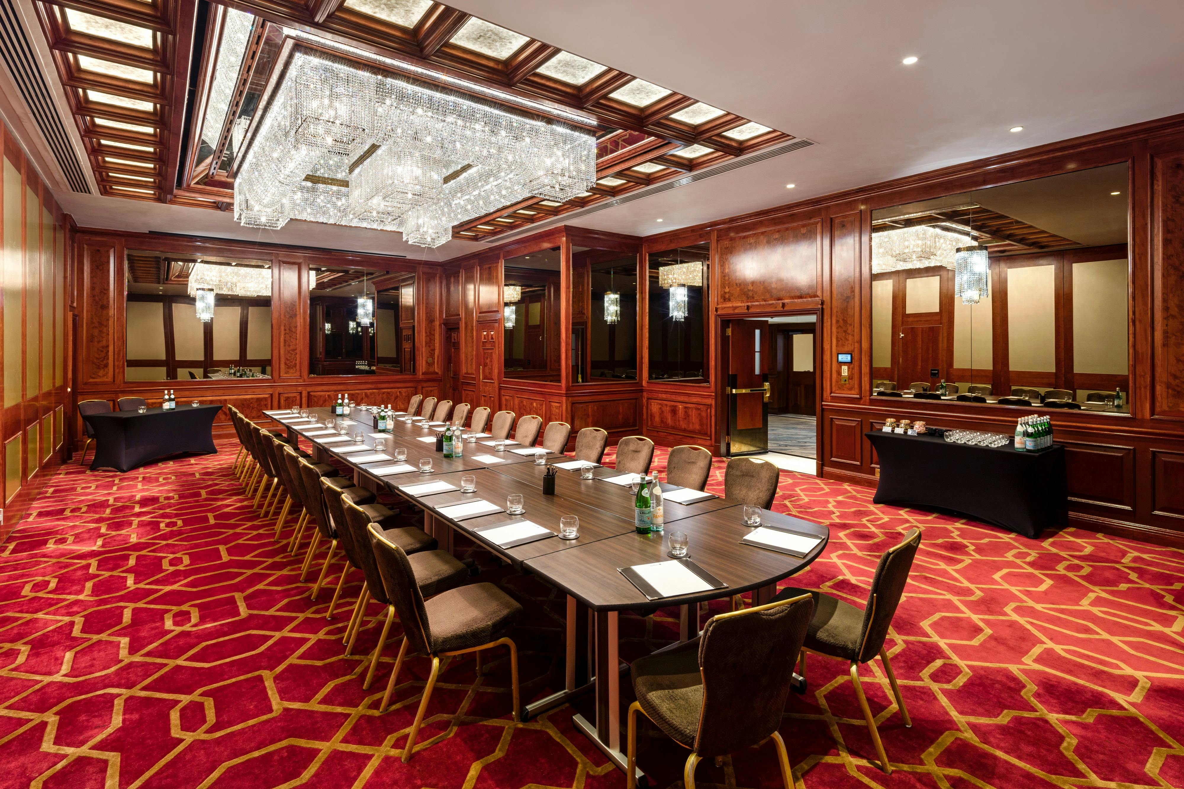 Sophisticated meeting room with chandelier at Radisson Blu Edwardian Heathrow for corporate events.