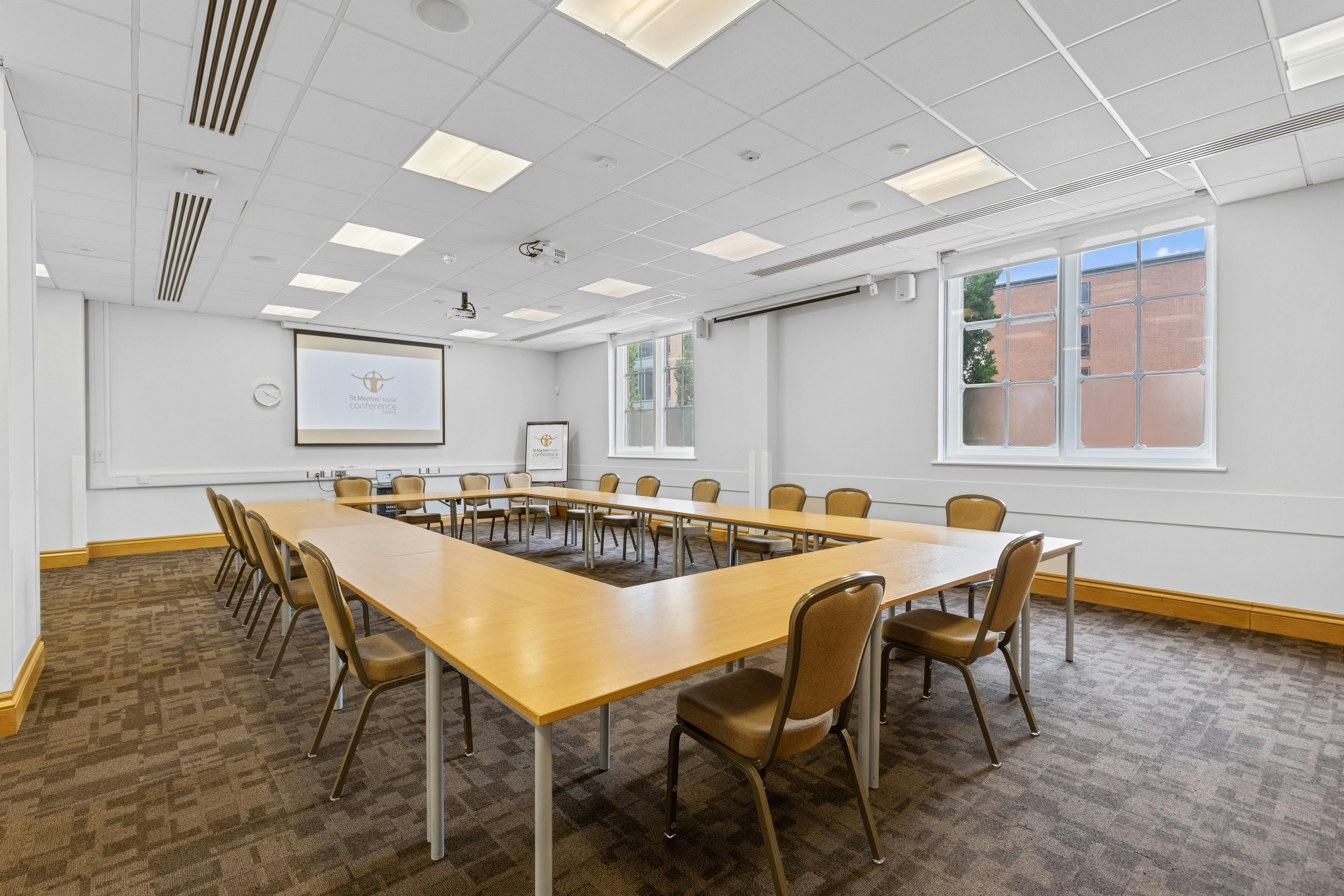 Modern Wycliffe Room with U-shaped table for workshops at St Martins House Conference Centre.