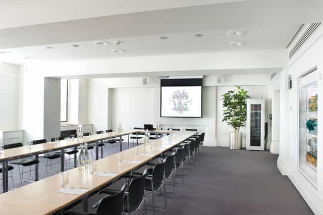 Modern meeting room with long table and ergonomic chairs for corporate workshops.
