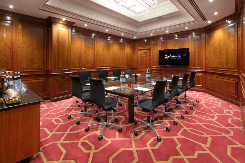 Private Room 31 at Radisson Blu Heathrow, featuring wood paneling for meetings and presentations.