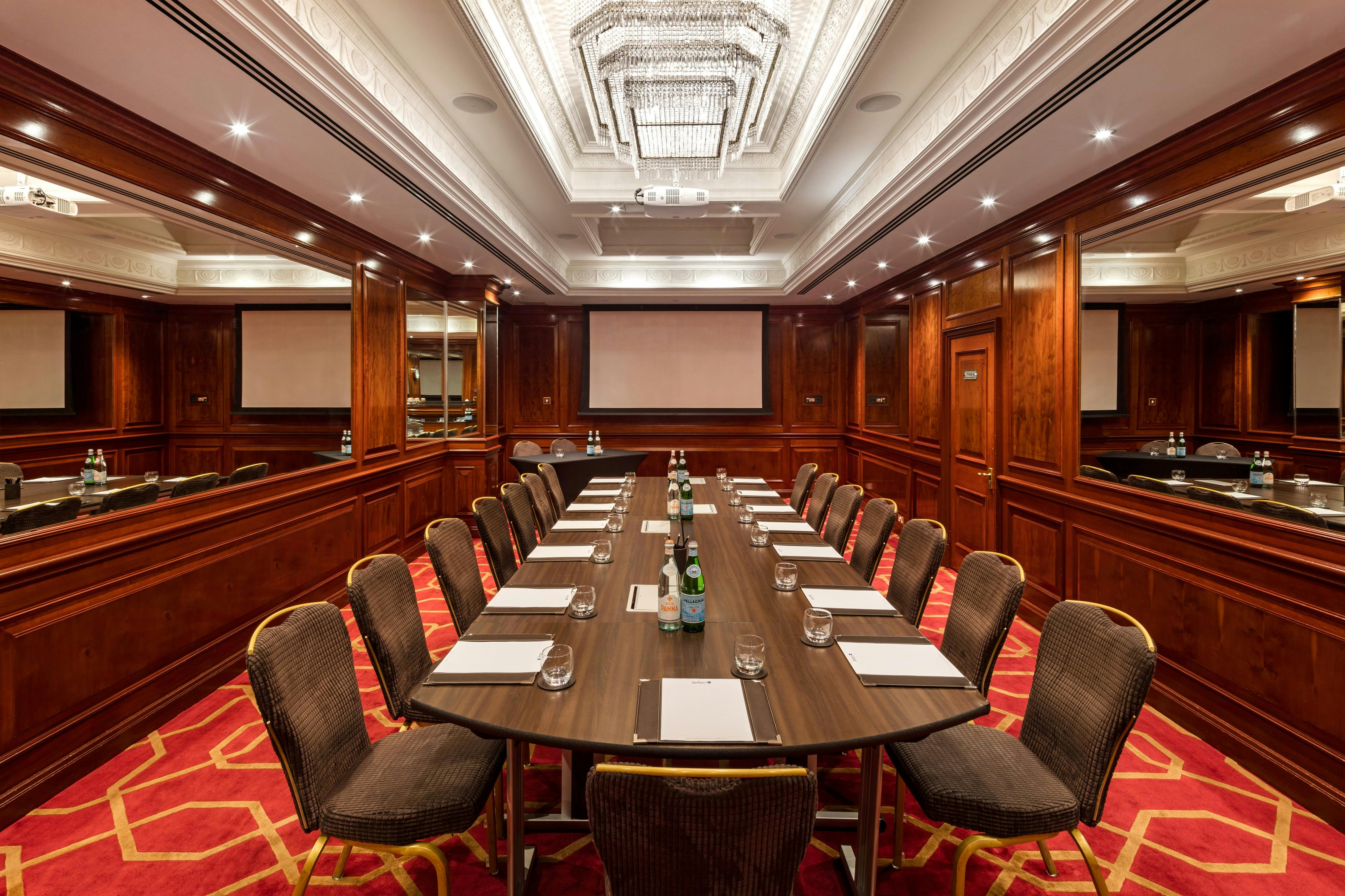 Private Room 32 at Radisson Blu Heathrow, elegant meeting space with modern AV setup.