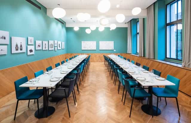 Private dining room with elegant table setup, ideal for corporate meetings and gatherings.