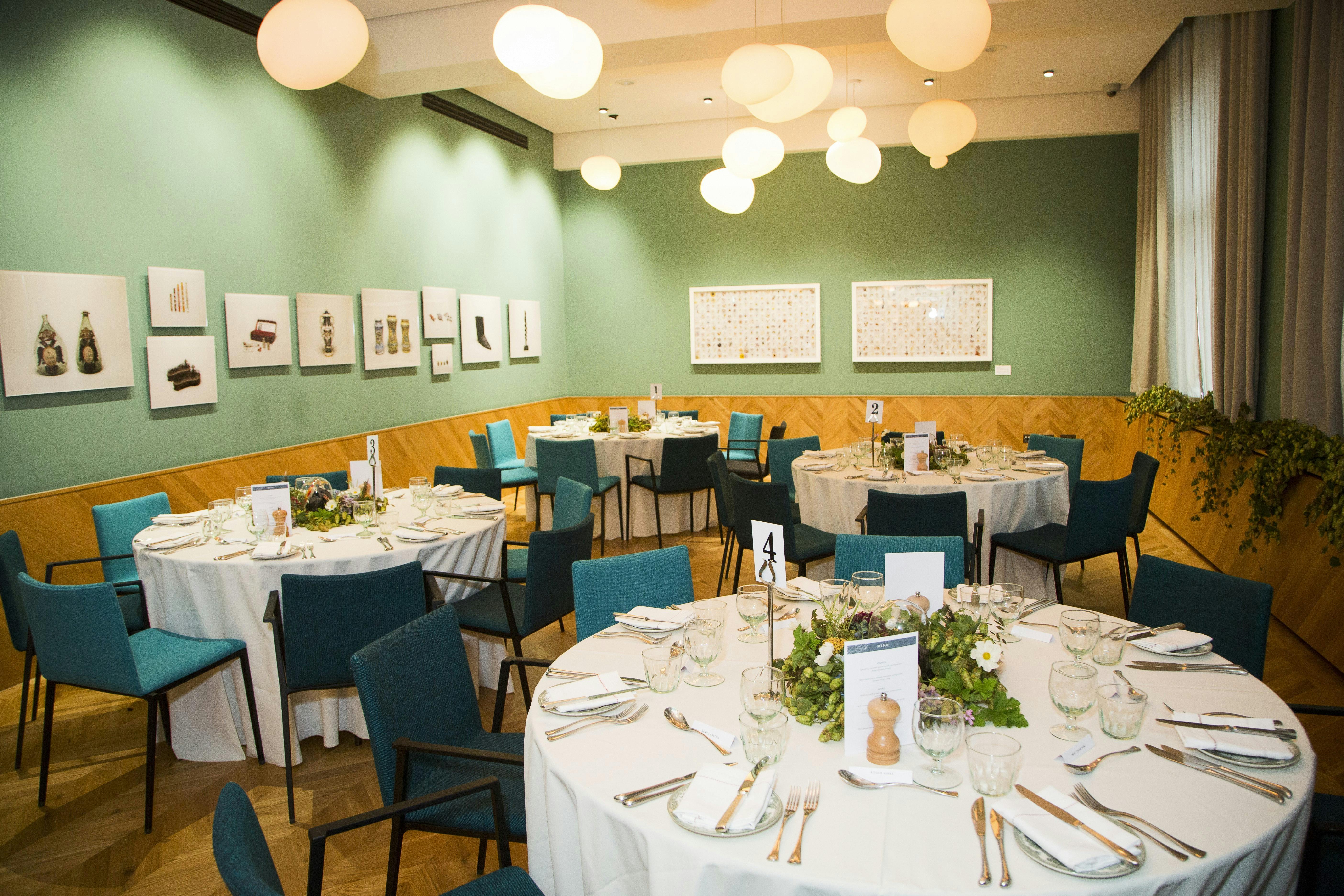 Private dining room with elegant round tables, ideal for corporate events and receptions.