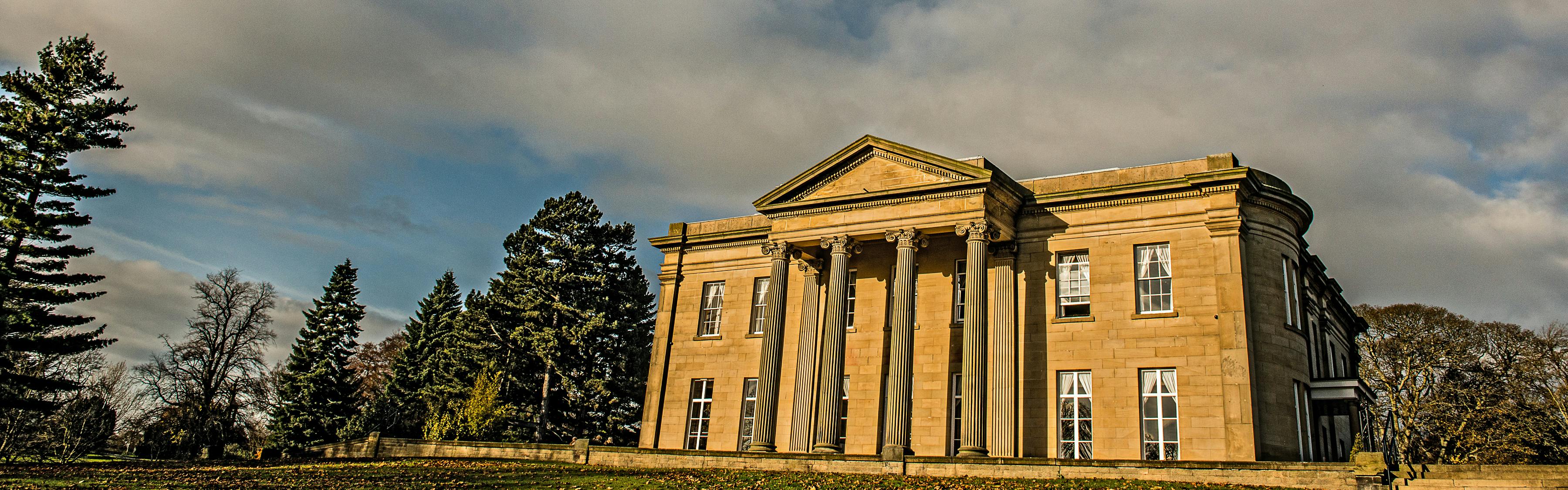 Elegant mansion venue with grand columns, perfect for upscale events and corporate retreats.