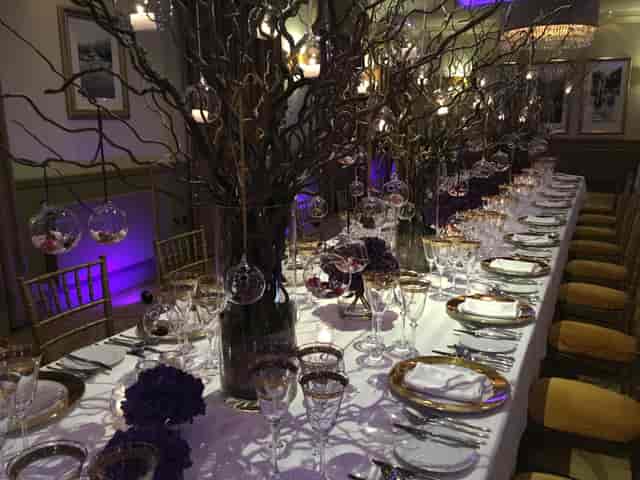 Elegant dining setup with centerpieces for upscale events at The Mansion.