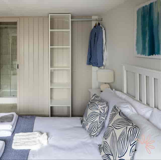 Cozy guest room at Spring Cottage with inviting bedding, ideal for event attendees.
