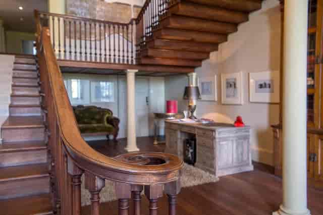 Elegant entryway with grand staircase at Howsham Hall for events and gatherings.
