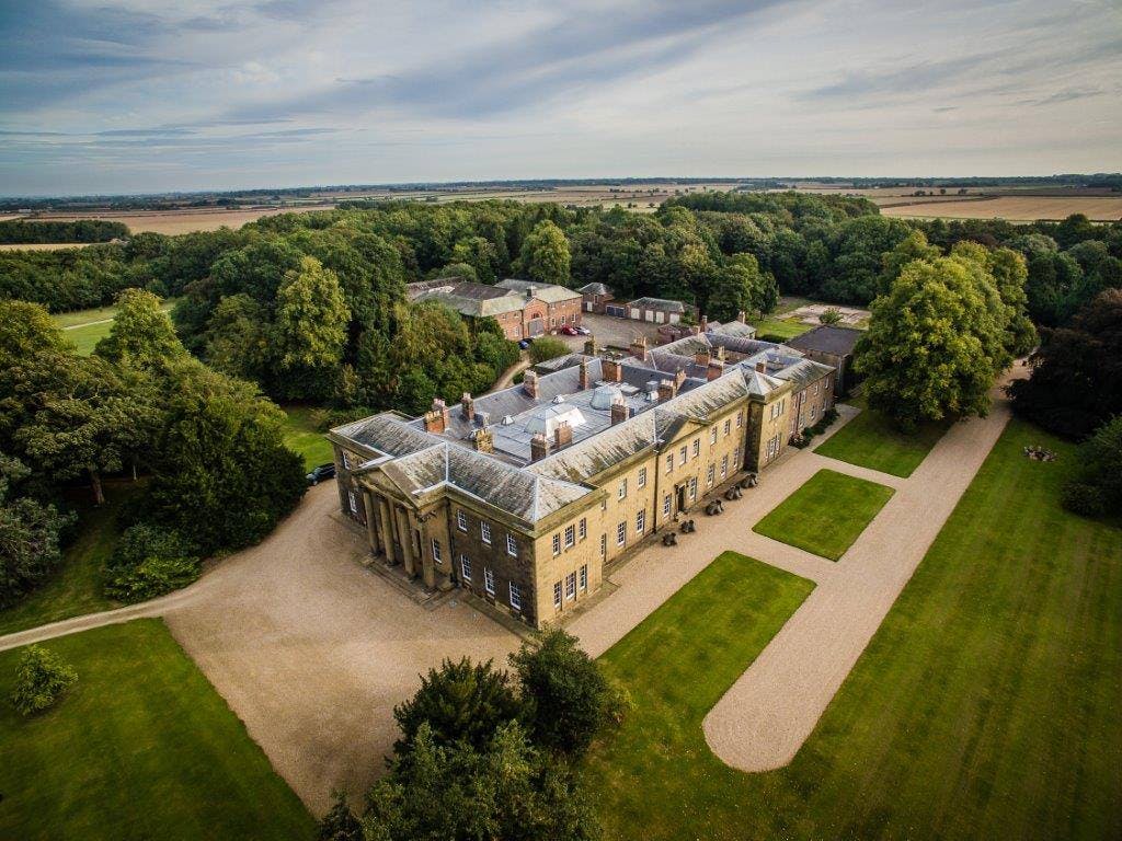 Elegant Rise Hall venue surrounded by greenery, ideal for upscale events and meetings.