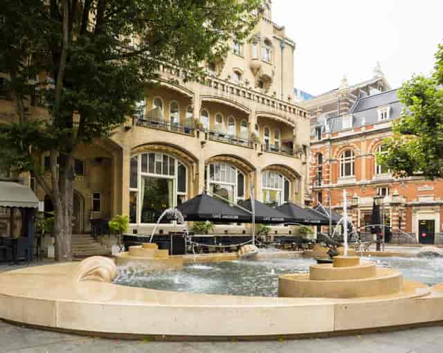 W. Kromhout and Ed Cuypers at Hard Rock Hotel Amsterdam outdoor event venue with fountain.