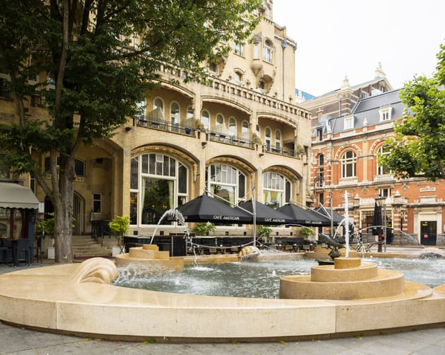 W. Kromhout and Ed Cuypers at Hard Rock Hotel Amsterdam outdoor event venue with fountain.