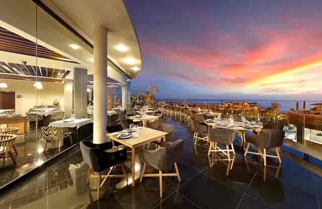 Outdoor dining at Woodstock, Hard Rock Hotel Tenerife, with sunset views for upscale events.