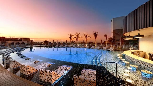 Woodstock poolside venue at Hard Rock Hotel Tenerife, perfect for upscale events at sunset.