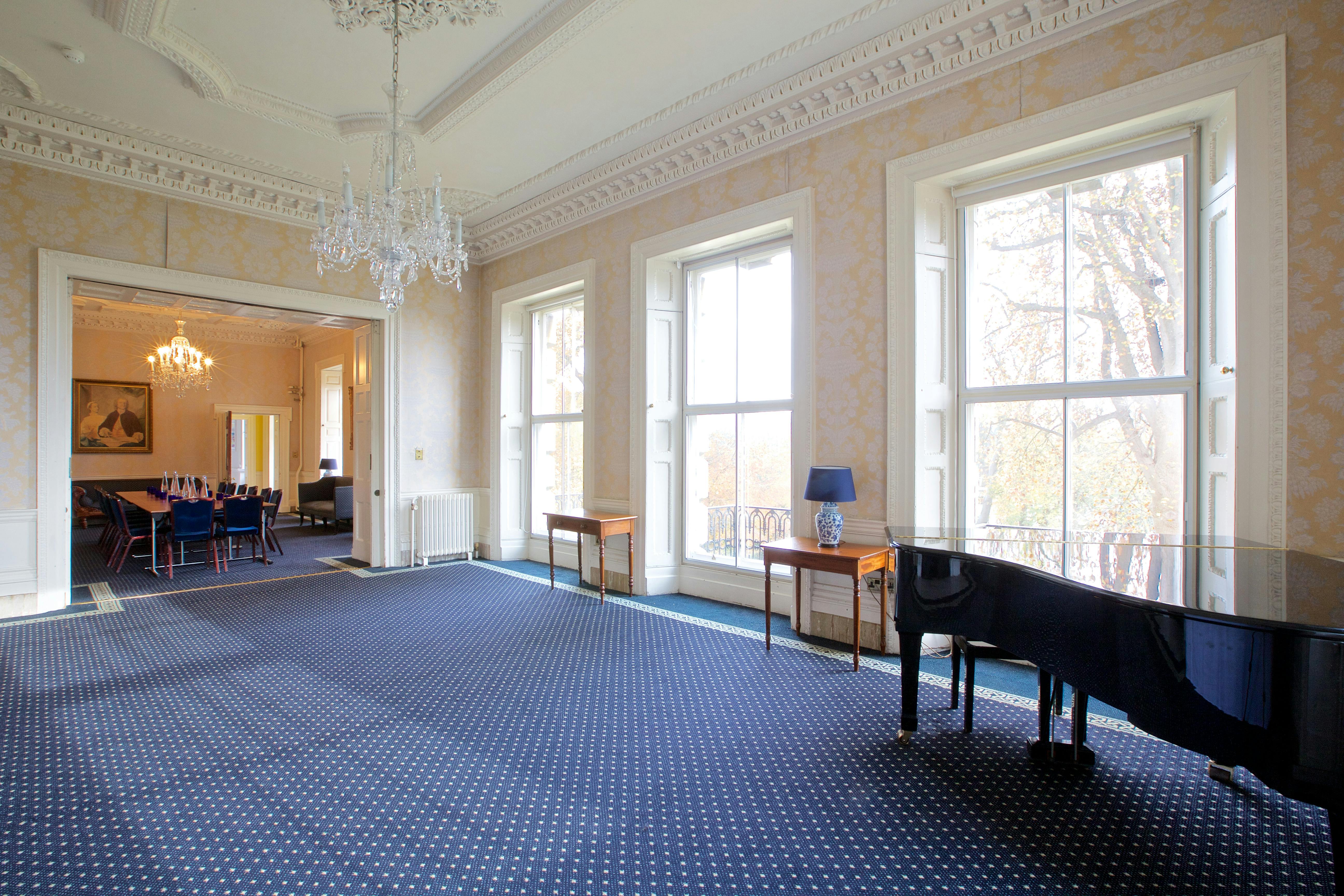 Elegant event space at Clifton Hill House with large windows and grand piano for receptions.