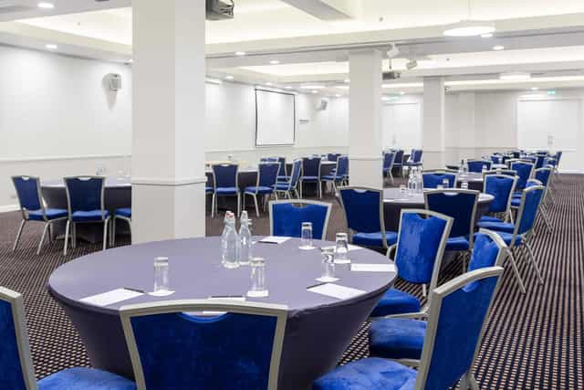 Daugava Ballroom meeting space with round tables, ideal for corporate workshops.