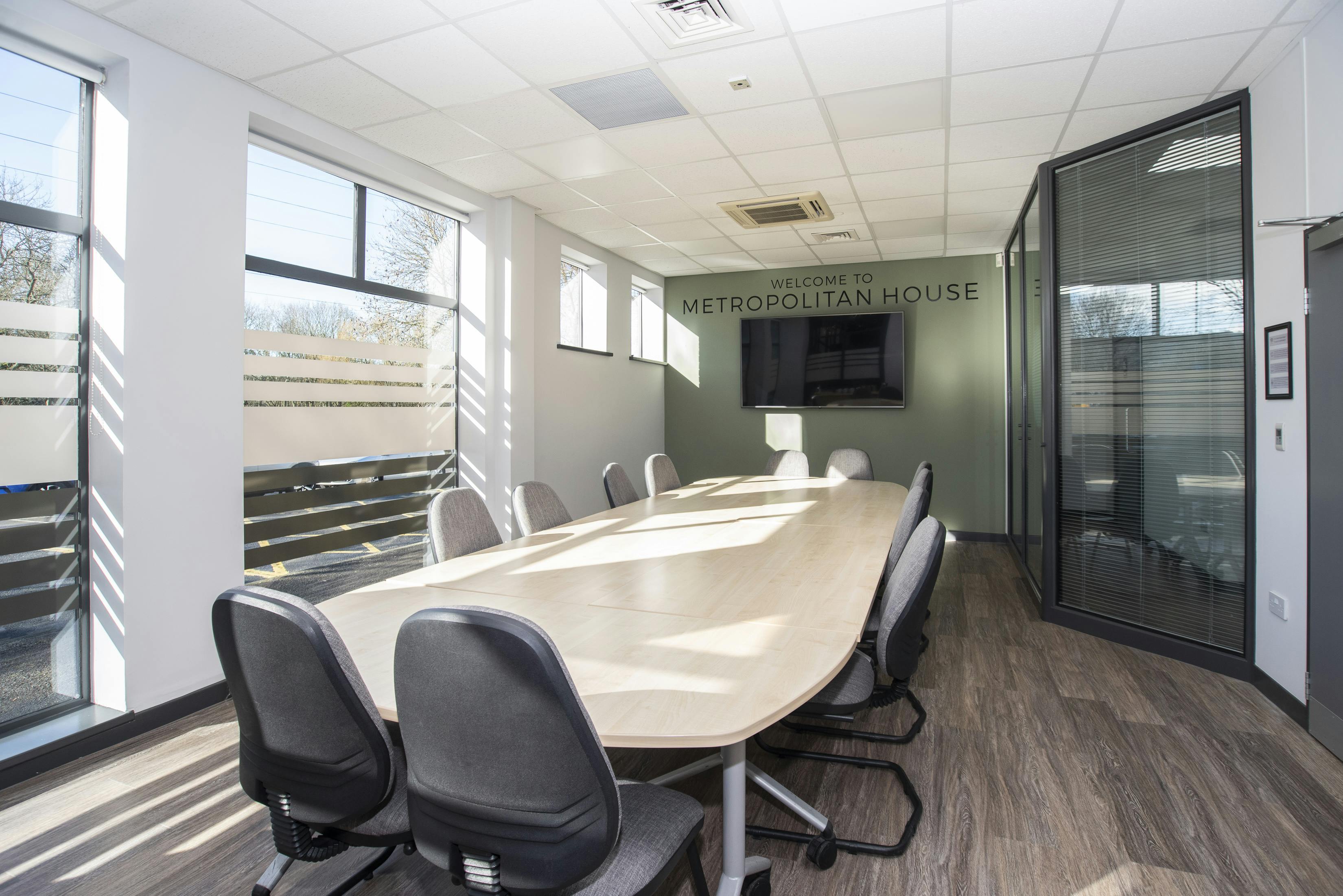 Modern meeting room with oval table, perfect for business conferences and presentations.