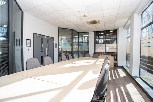 Modern conference room with spacious table and natural light for meetings and events.