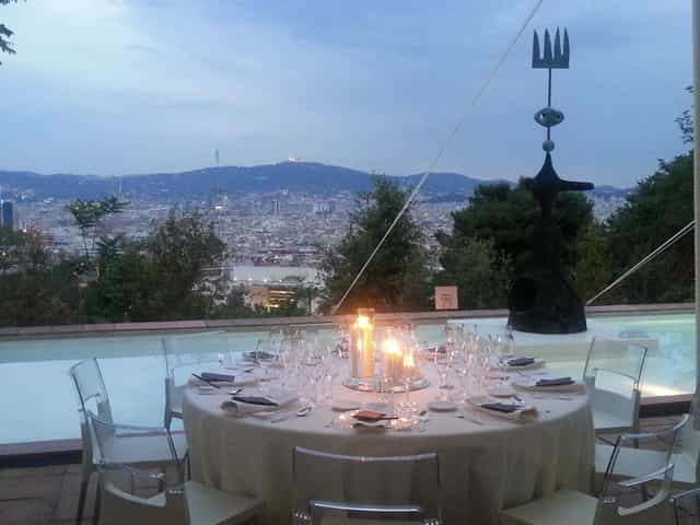 Elegant outdoor dining setup with city view at Fundació Joan Miró for upscale events.