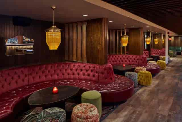 Main Hall Exclusive lounge with plush red seating for networking events and gatherings.