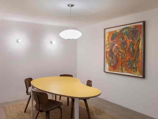 Modern meeting space with yellow table for collaborative events at Arc Club.