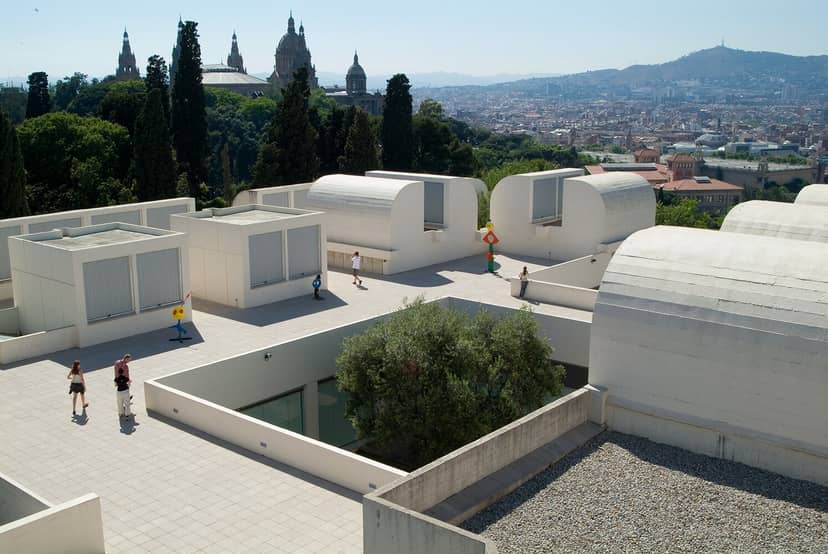 Modern outdoor event venue at Fundació Joan Miró with lush greenery backdrop.