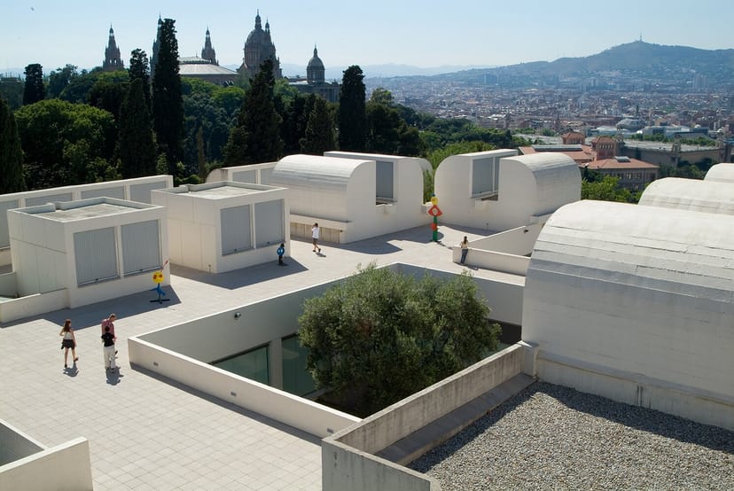 Modern outdoor event venue at Fundació Joan Miró with lush greenery backdrop.
