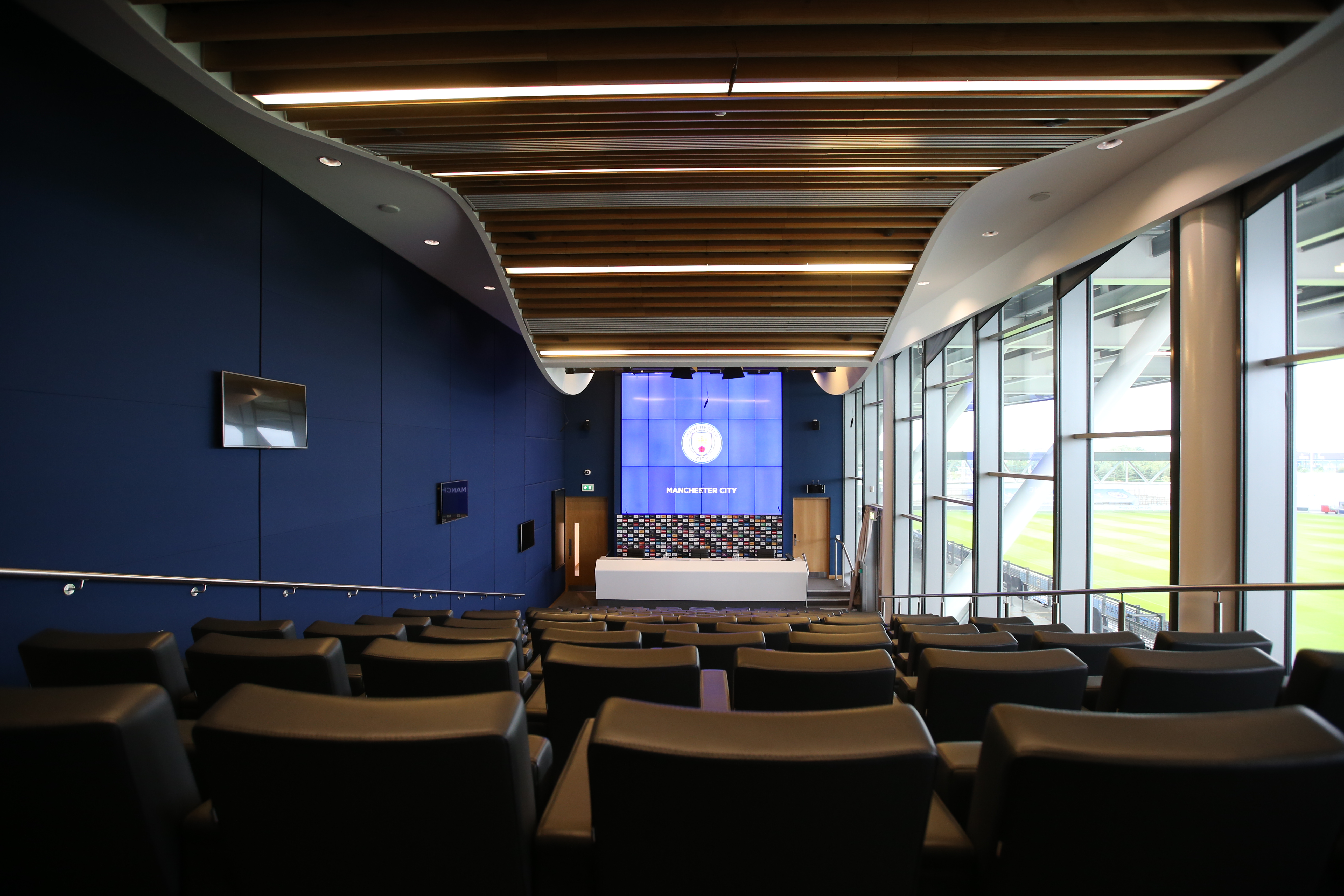 Modern event space at City Football Academy with sleek seating for corporate meetings. - Banner