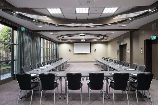 U-shaped meeting room with natural light at Bilderberg Garden Hotel for workshops.