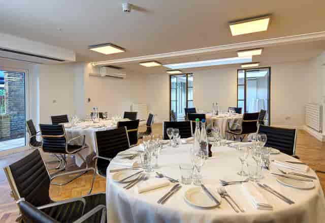 St John Groser room, modern dining setup with elegant tables for events and meetings.