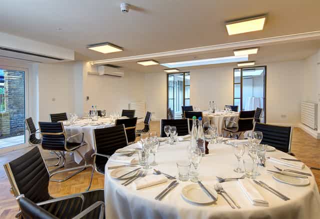 St John Groser room, modern dining setup with elegant tables for events and meetings.