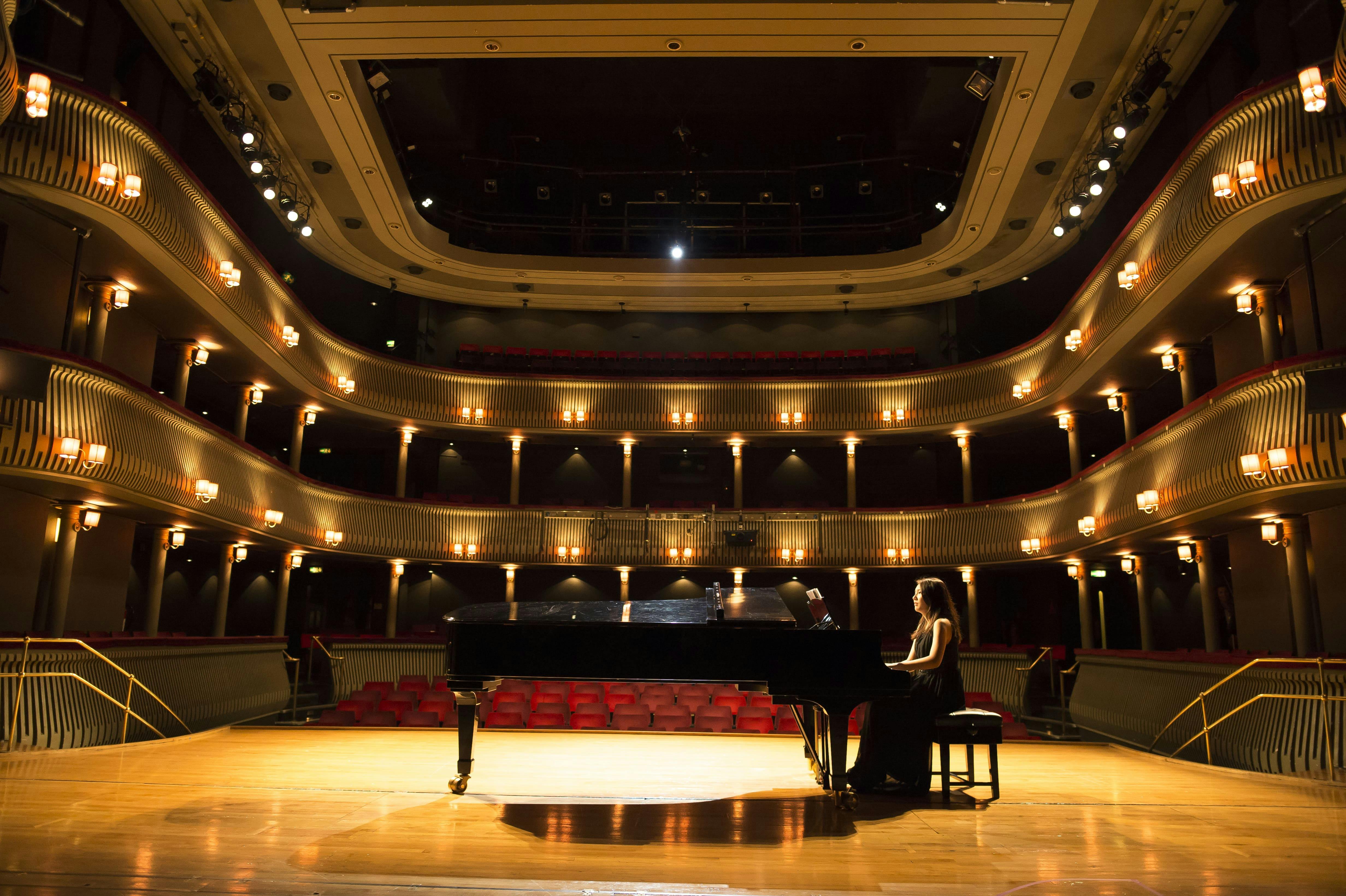 Britten Theatre concert hall with grand piano, ideal for performances and events.