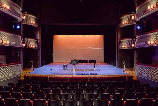 Britten Theatre stage with grand piano, ideal for concerts and performances.