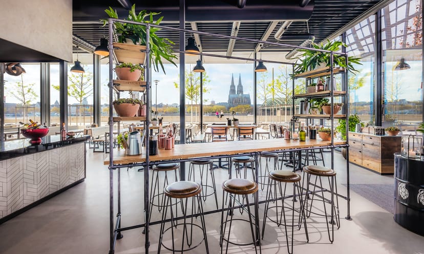 Modern event space at Sticky Fingers with stylish bar and greenery for gatherings.